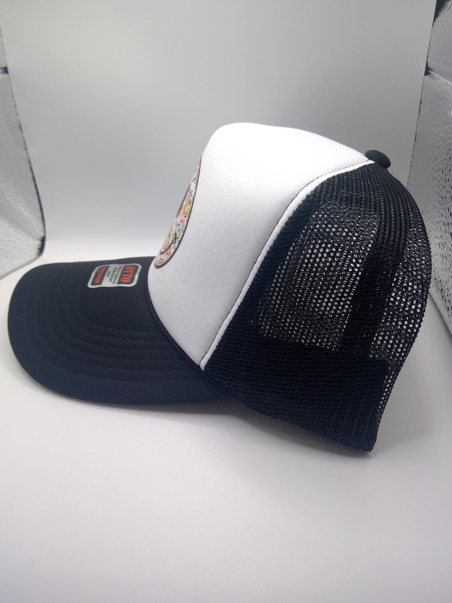 Retro smiley face black trucker hat